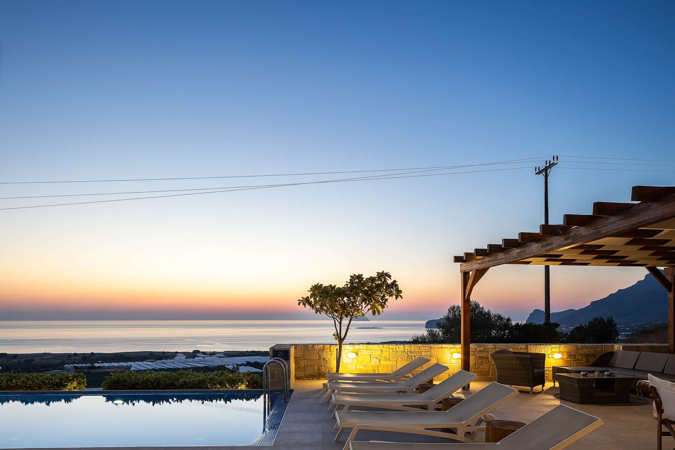 Sunset view from the infinity pool at Falasarna Luxury Villas Chania overlooking the sea