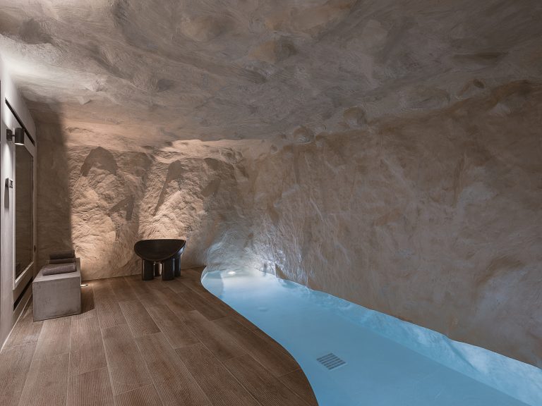 Indoor spa pool inside stone cave at City Moments Villa