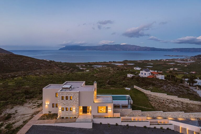 Night exterior of Rastoni Villa Chania overlooking the sea and surrounding landscape
